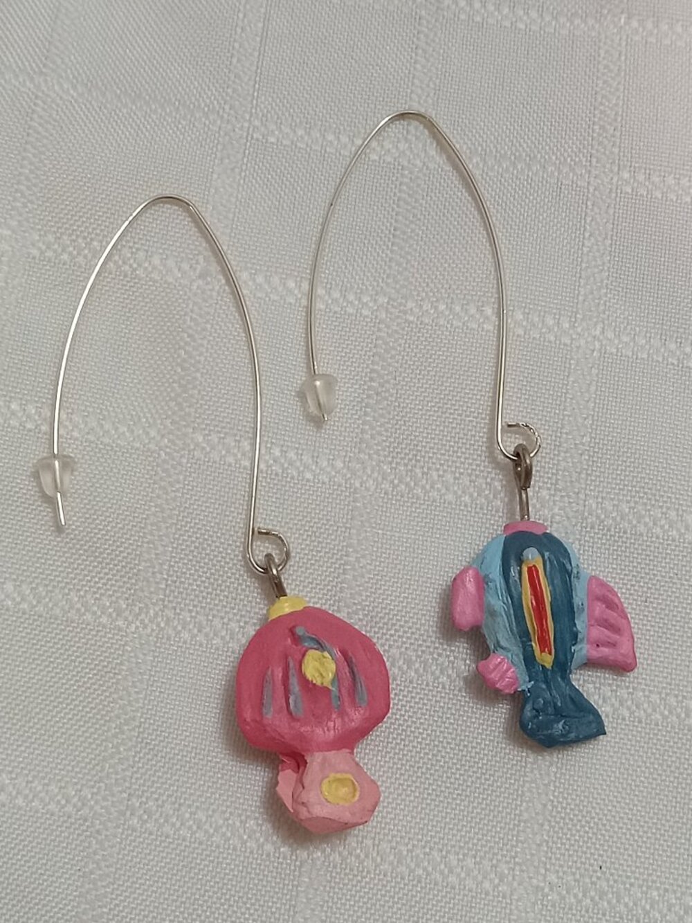 Handmade earrings featuring small, colorful fish